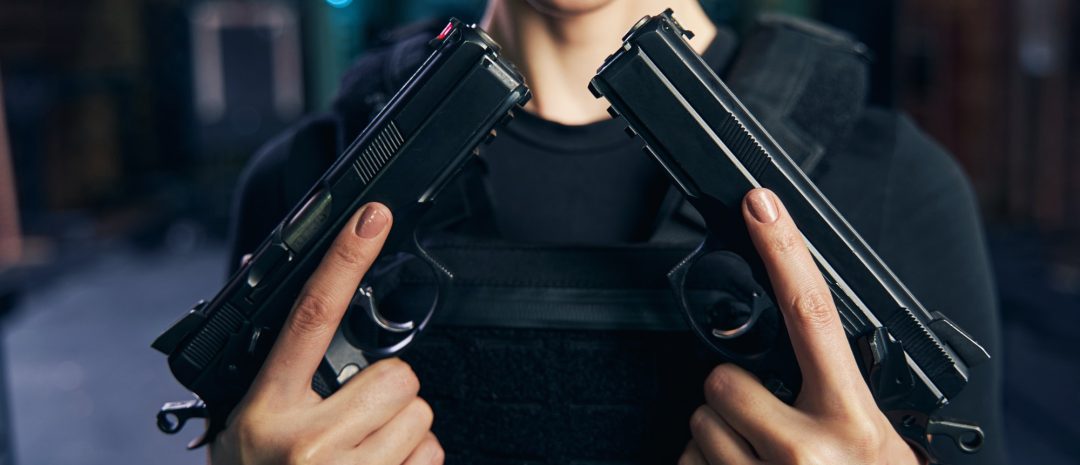 professional-caucasian-female-shooter-showing-her-two-handguns.jpg